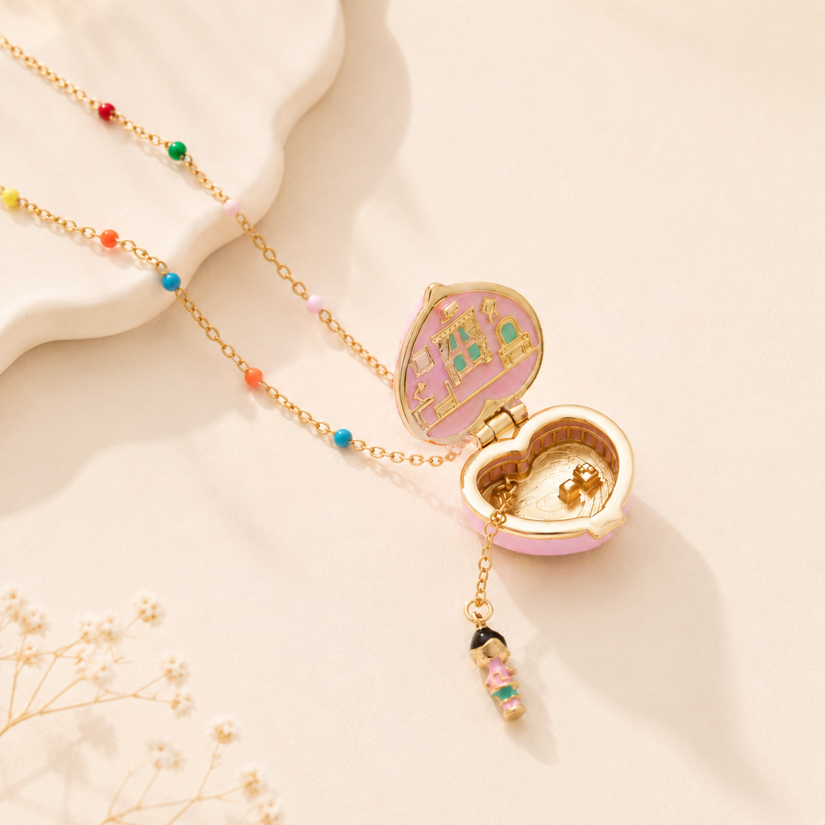 The Little World Locket open, with the little scene inside and the charm below