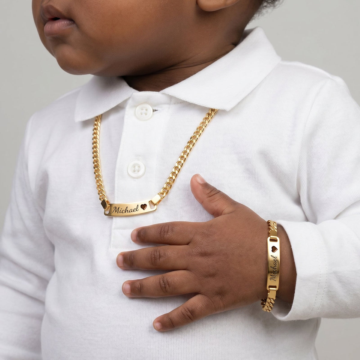 The Little Name Set in gold, worn by a child