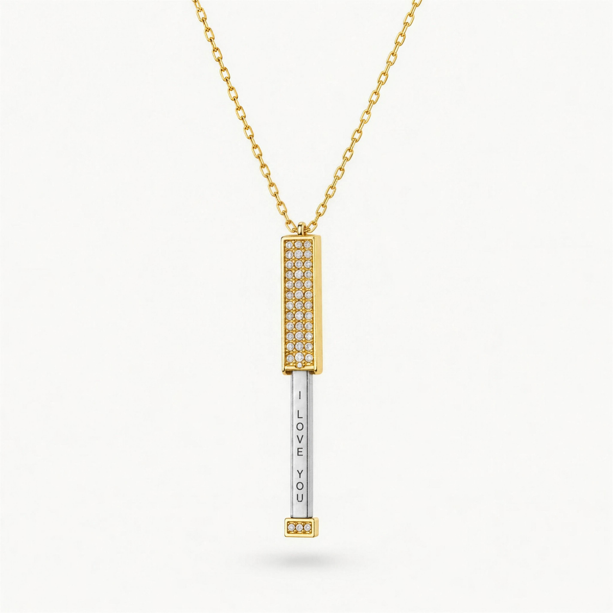 The I Love You Necklace in gold, opened to reveal the hidden I love you message